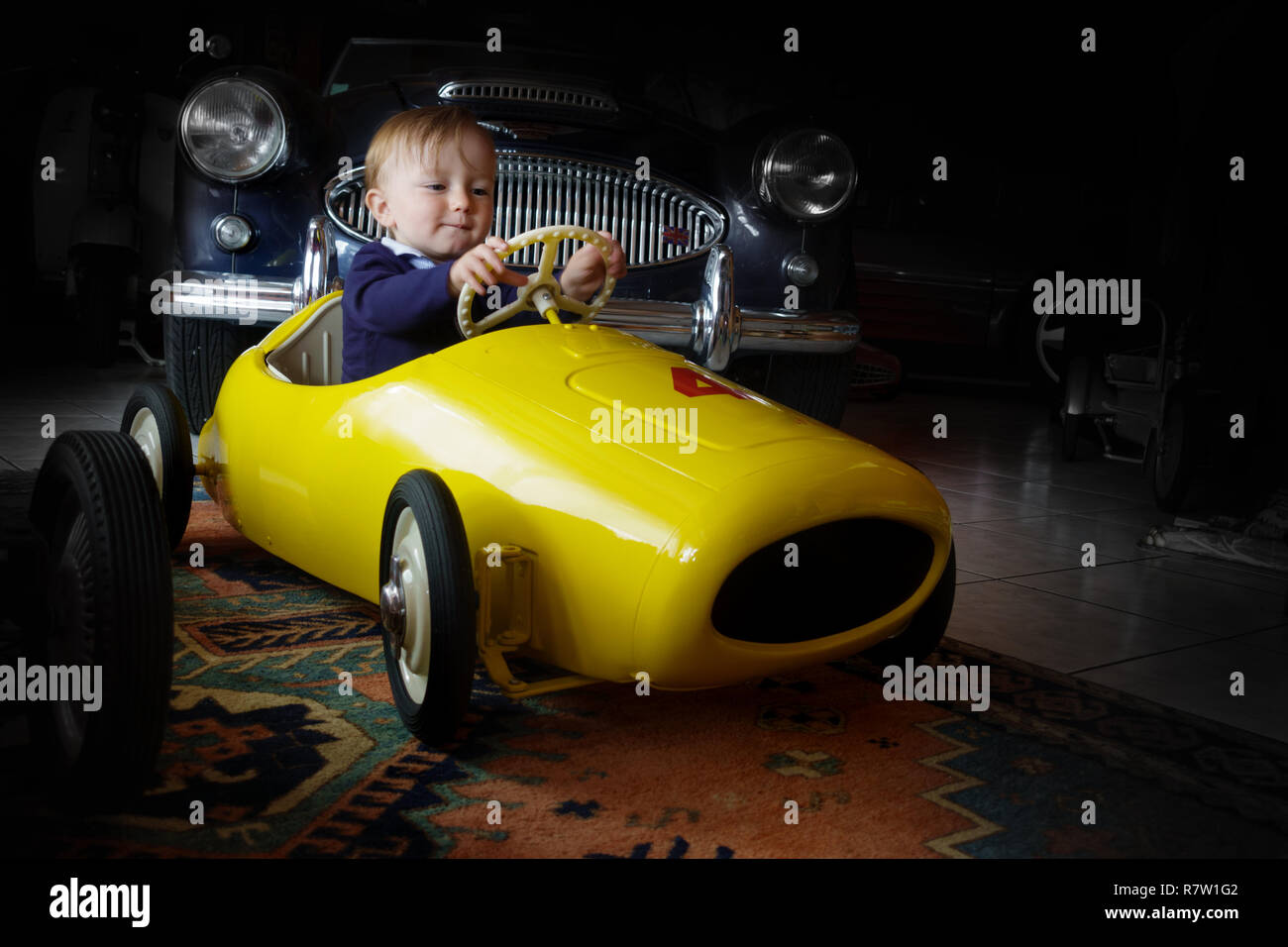 Baby boy driving toy car Stock Photo Alamy