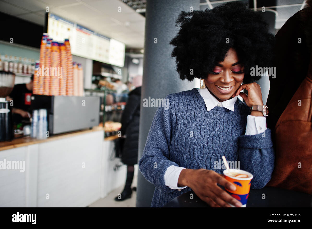 Curly Hair African American Woman Wear On Sweater Posed At Cafe