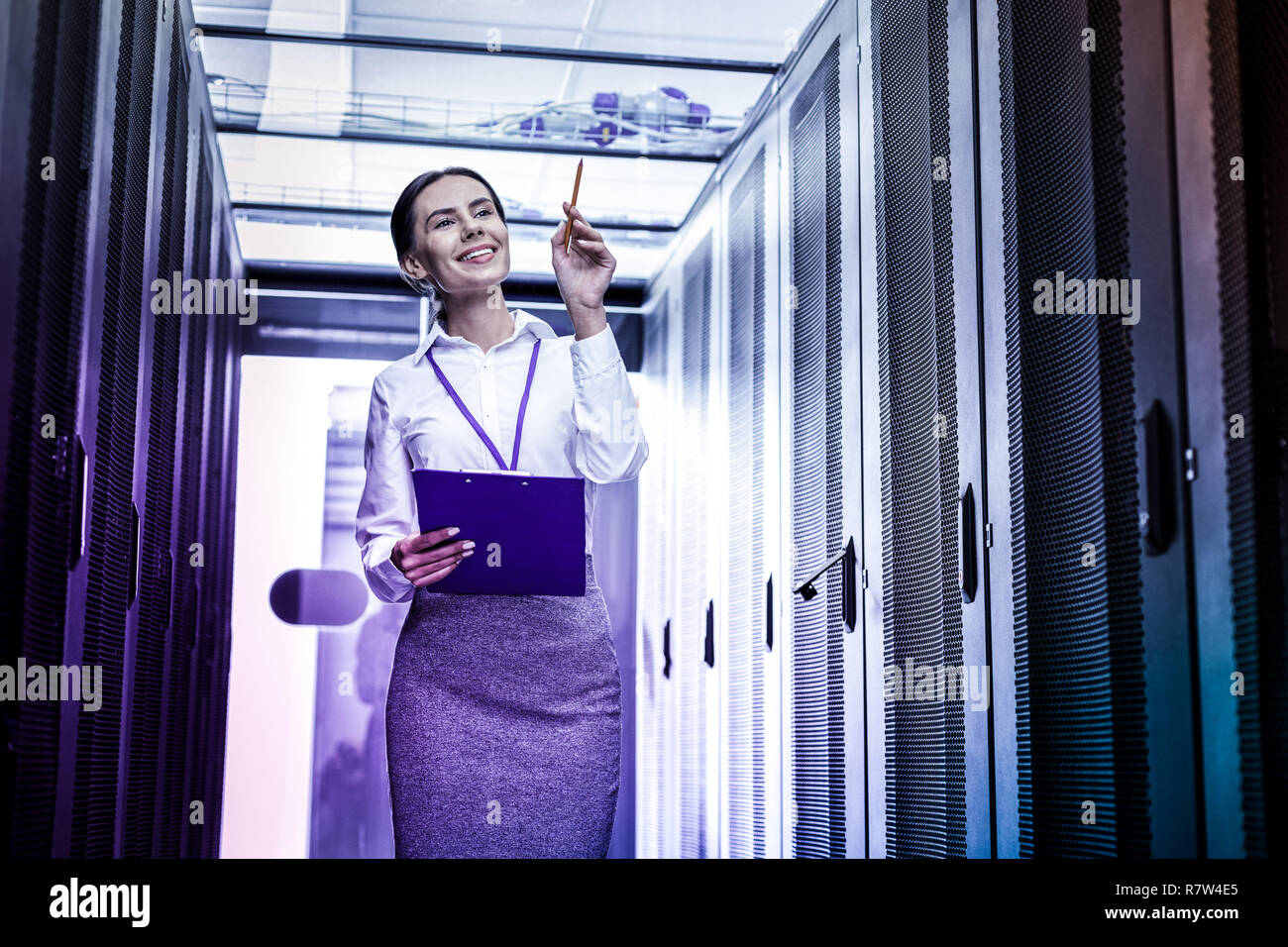 Positive smart young woman checking information systems Stock Photo