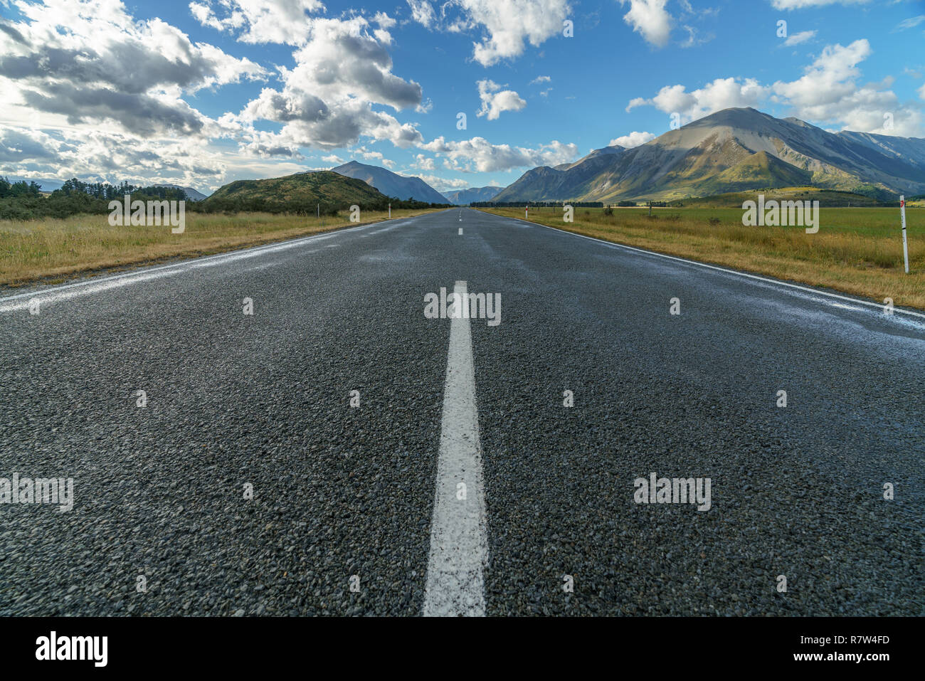on the road in the valley between mountains, arthurs pass, new zealand
