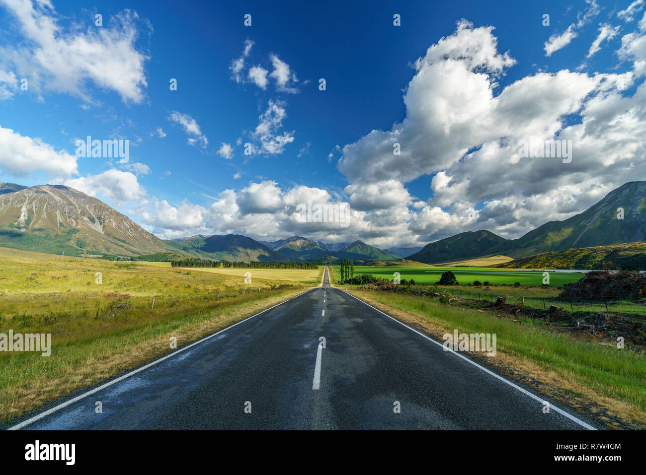on the road in the valley between mountains, arthurs pass, new zealand