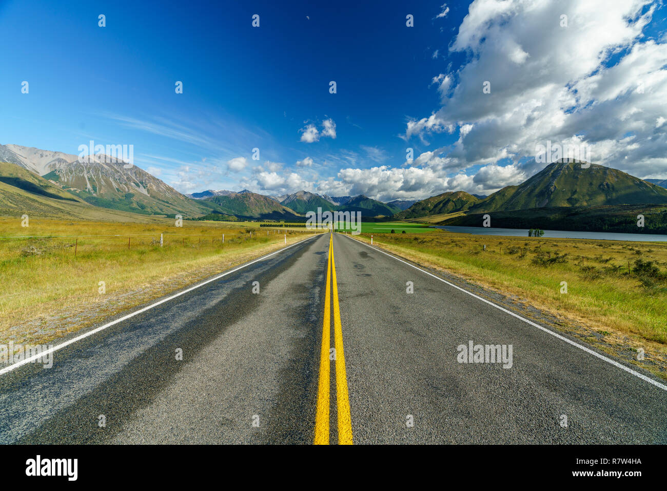 on the road in the valley between mountains, arthurs pass, new zealand