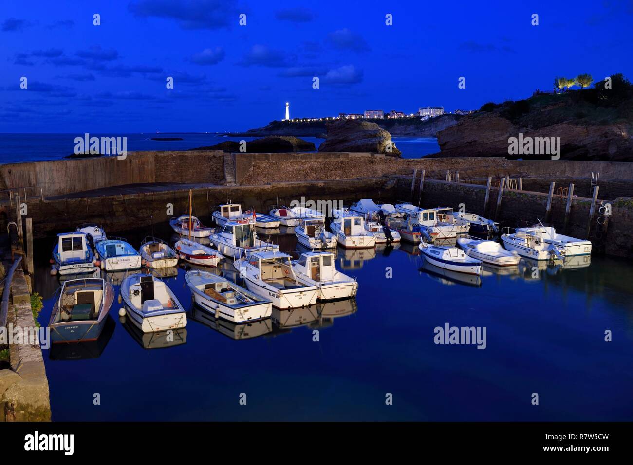 France, Pyrenees Atlantiques, Basque Country, Biarritz, Port des Pecheurs, the lighthouse and the rocher du Basta in the background Stock Photo