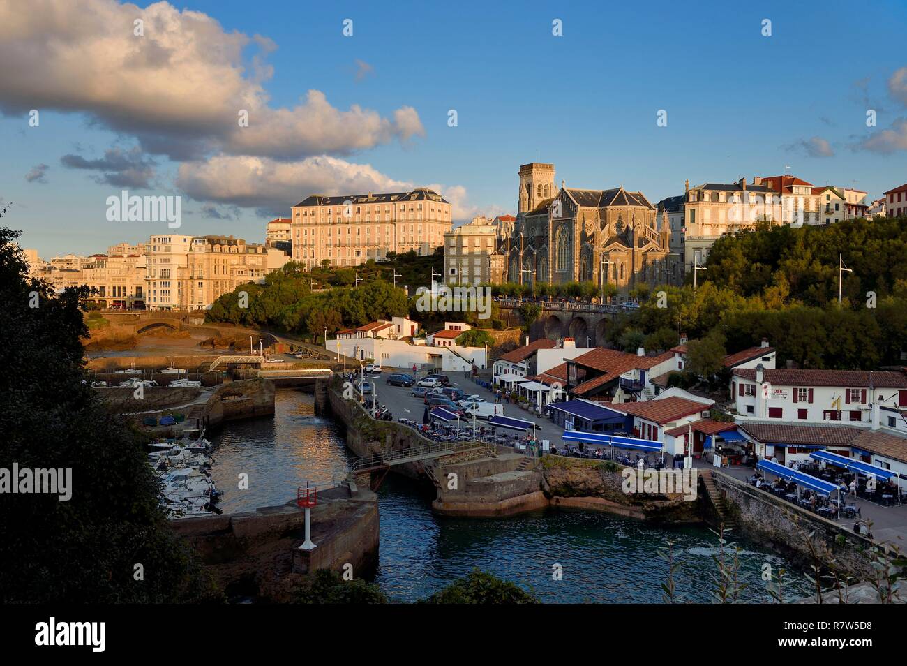France, Pyrenees Atlantiques, Basque Country, Biarritz, Port des Pecheurs, Sainte Eugenie church and facades of the buildings located on Grande Plage (Great beach) Stock Photo