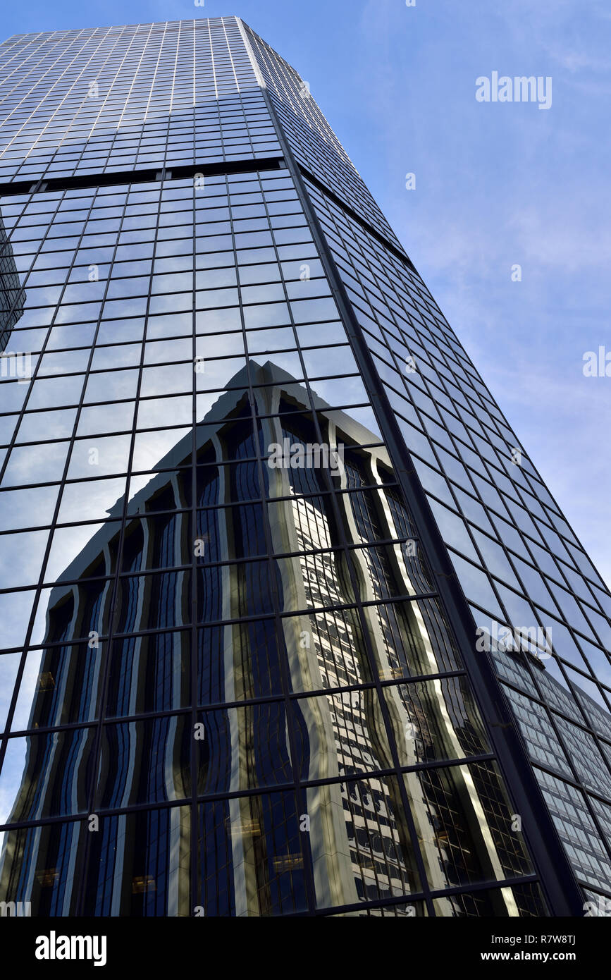 Office tower block with reflection of adjacent office block in its windows Stock Photo