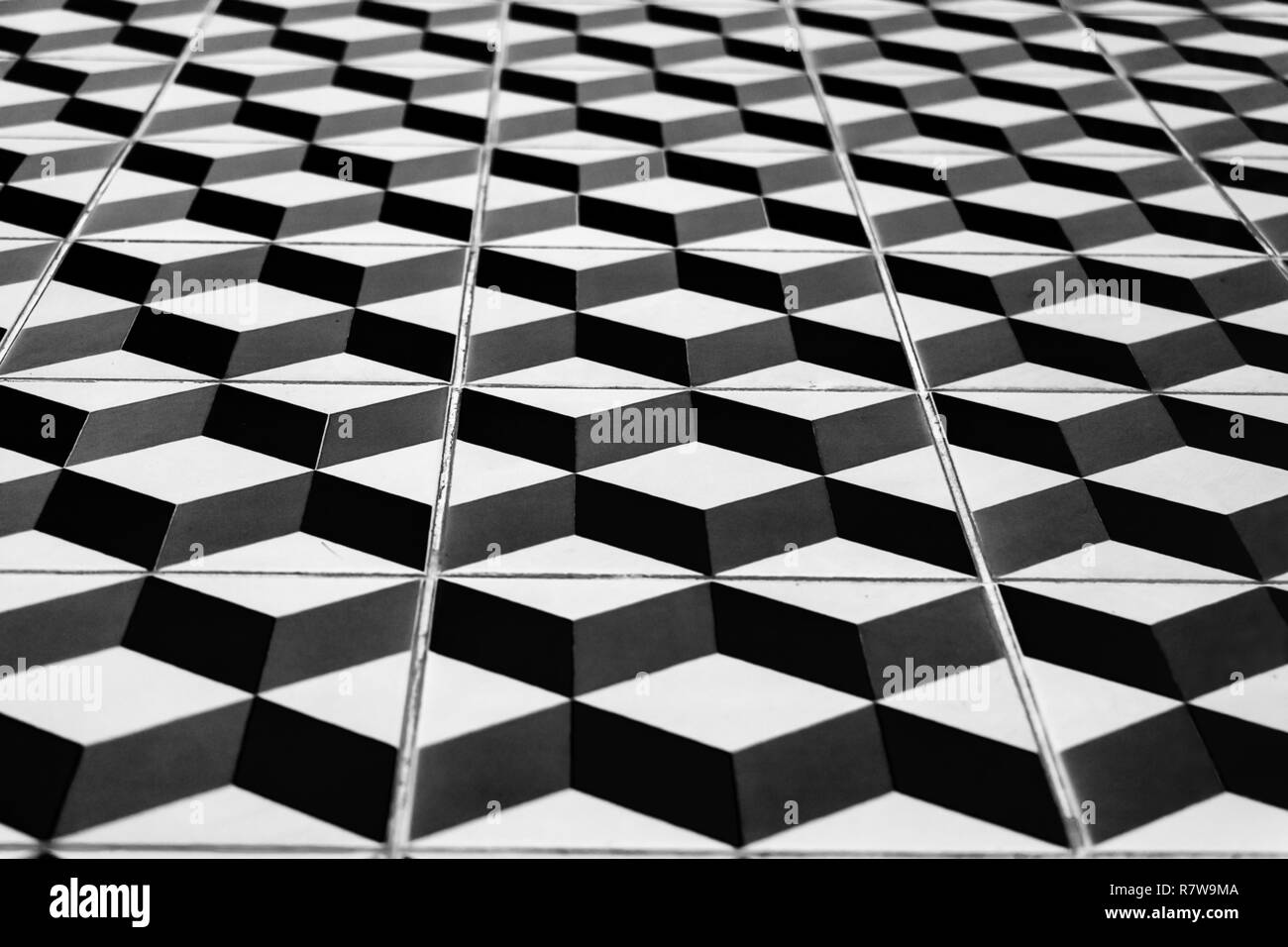Perspective view of the floor of retro tiles. Repeating geometric patterns of dice on the floor of ceramic tile. Stock Photo