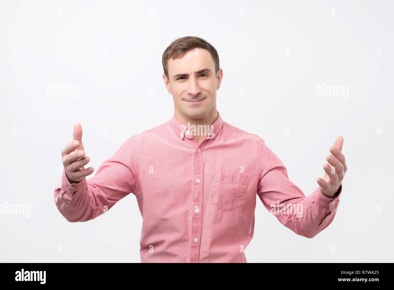Argue, arguing concept. Young emotional surprised man looking at camera. Stock Photo
