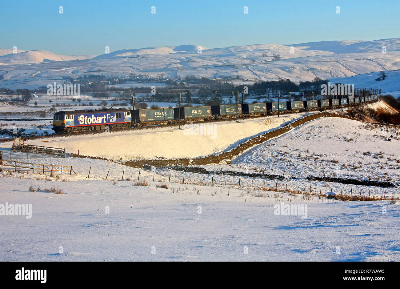 92017 passes Greenholme with the Tesco Express. Stock Photo