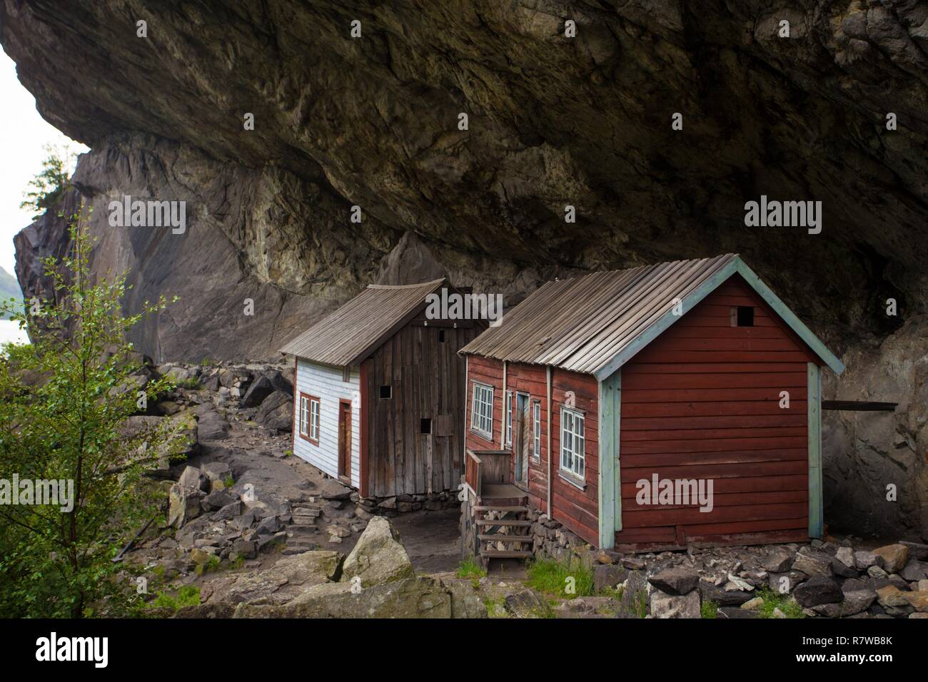 two houses of ancient settlement below rock Helleren,  Jossingfjord, Stavanger, Southern Norway Stock Photo