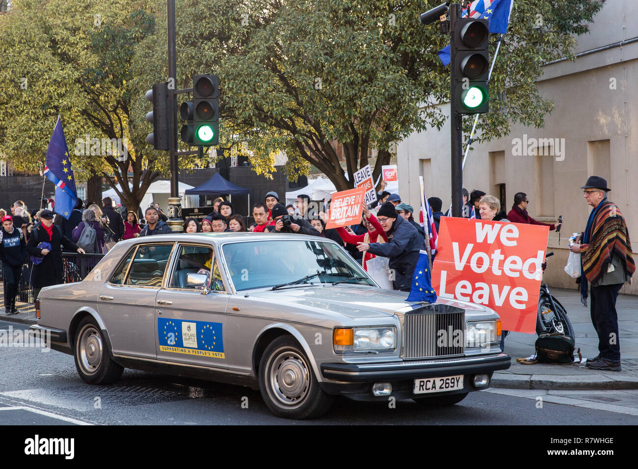 London, UK. 11th December, 2018. Pro-Brexit activists jeer at the occupants of a Rolls Royce adorned with pro-EU stickers and an EU flag during rival protests outside Parliament on the day on which a vote was originally to have been scheduled on completion of a House of Commons debate on the Government's draft Brexit withdrawal agreement. Credit: Mark Kerrison/Alamy Live News Stock Photo
