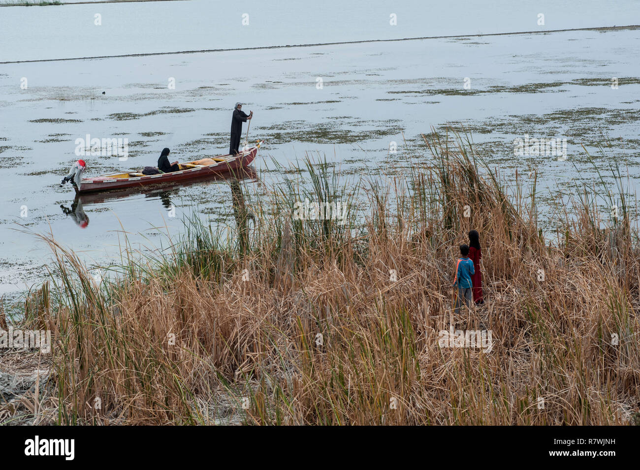 November 3, 2018 - Al-Chibayish, Marshes of Southern Iraq, Iraq - Marsh Arabs seen on the river Euphrates at Al-Chibayish in the Southern wetlands of Iraq.Climate change, dam building in Turkey and internal water mismanagement are the main causes of a severe drought in the southern wetlands of Iraq. Credit: John Wreford/SOPA Images/ZUMA Wire/Alamy Live News Stock Photo