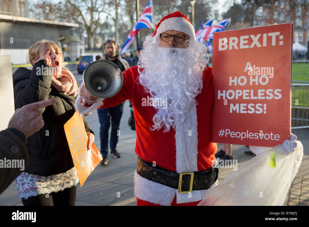 London, UK 11th December 2018: As Prime Minister Theresa May tours European capitals hoping to persuade foreign leaders to accept a new Brexit deal (following her cancellation of a Parliamentary vote), a pro-EU Santa ringing a Brexit bell is taunted by Brexiteers during a protest opposite the Houses of Parliament, on 11th December 2018, in London, England. Photo by Richard Baker / Alamy Live News Stock Photo