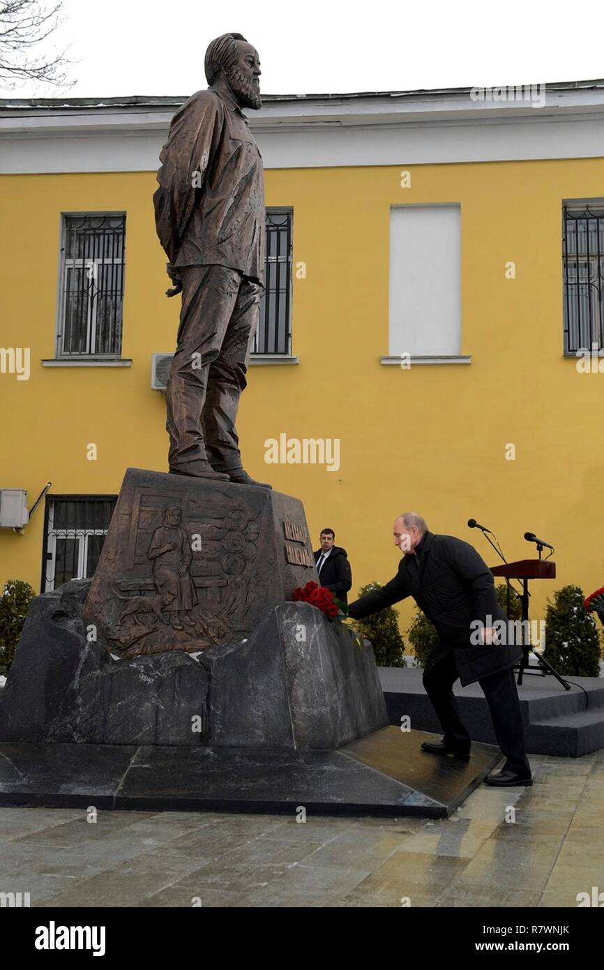 Russian President Vladimir Putin places flowers on a newly unveiled monument to Nobel laureate Alexander Solzhenitsyn marking the 100th anniversary of his birth December 11, 2018 in Moscow, Russia. Stock Photo