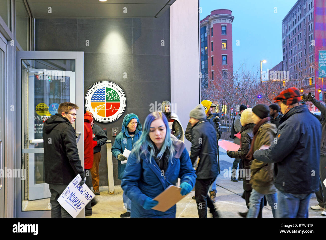 Cleveland, Ohio, USA, 11th Dec, 2018.  Protesters enter the Cuyahoga County Administration building to attend the Cuyahoga County Council meeting during which the reported 'inhumane' conditions of the jails will be addressed.  U.S. Marshals have called the county jails to be among the worst in the country citing overcrowding, underadministered healthcare, safety, access to toilets, and the withholding of food and water amongst the offenses reported.  The U.S Marshalls were summoned to conduct a review after deaths of 7 inmates occurred.  . Credit: Mark Kanning/Alamy Live News Stock Photo
