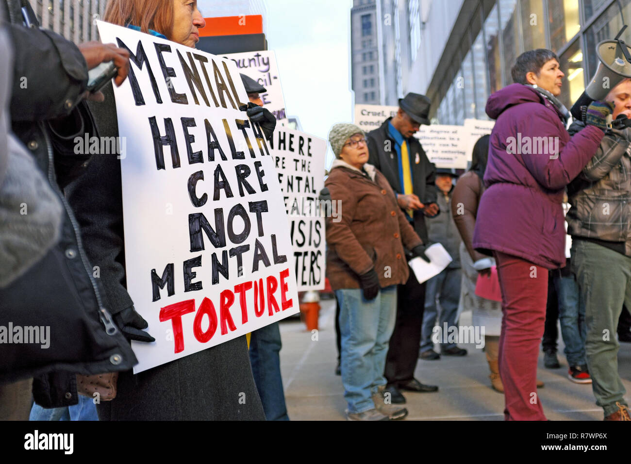 Cleveland, Ohio, USA, 11th Dec, 2018.  Protesters hold signs outside the Cuyahoga County Administration Building in downtown Cleveland, Ohio, USA prior to the council meeting addressing the inhumane conditions of the jails and the multiple deaths that have occurred to inmates over the previous six months.  Protesting address many of the issues identified by the federal inspection report by the U.S. Marshal service which found the conditions to be 'inhumane' and considered some of the worst jails in the United States. Credit: Mark Kanning/Alamy Live News Stock Photo