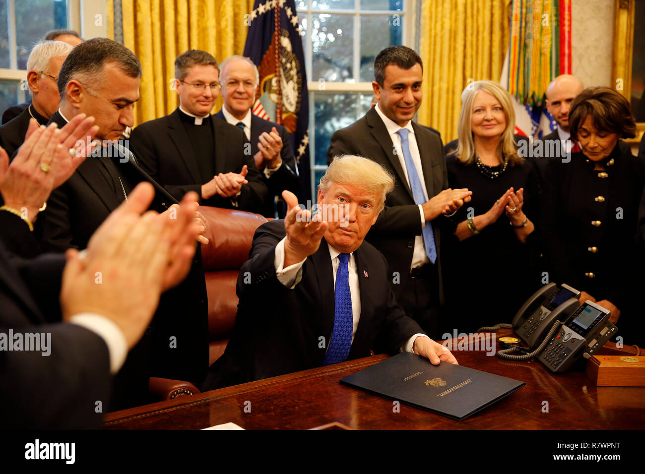 Washington, United States Of America. 11th Dec, 2018. United States President Donald J. Trump signs H.R. 390, the "Iraq and Syria Genocide Relief and Accountability Act of 2018" in the Oval Office of the White House, in Washington, DC, December 11, 2018. Credit: Martin H. Simon/CNP | usage worldwide Credit: dpa/Alamy Live News Stock Photo