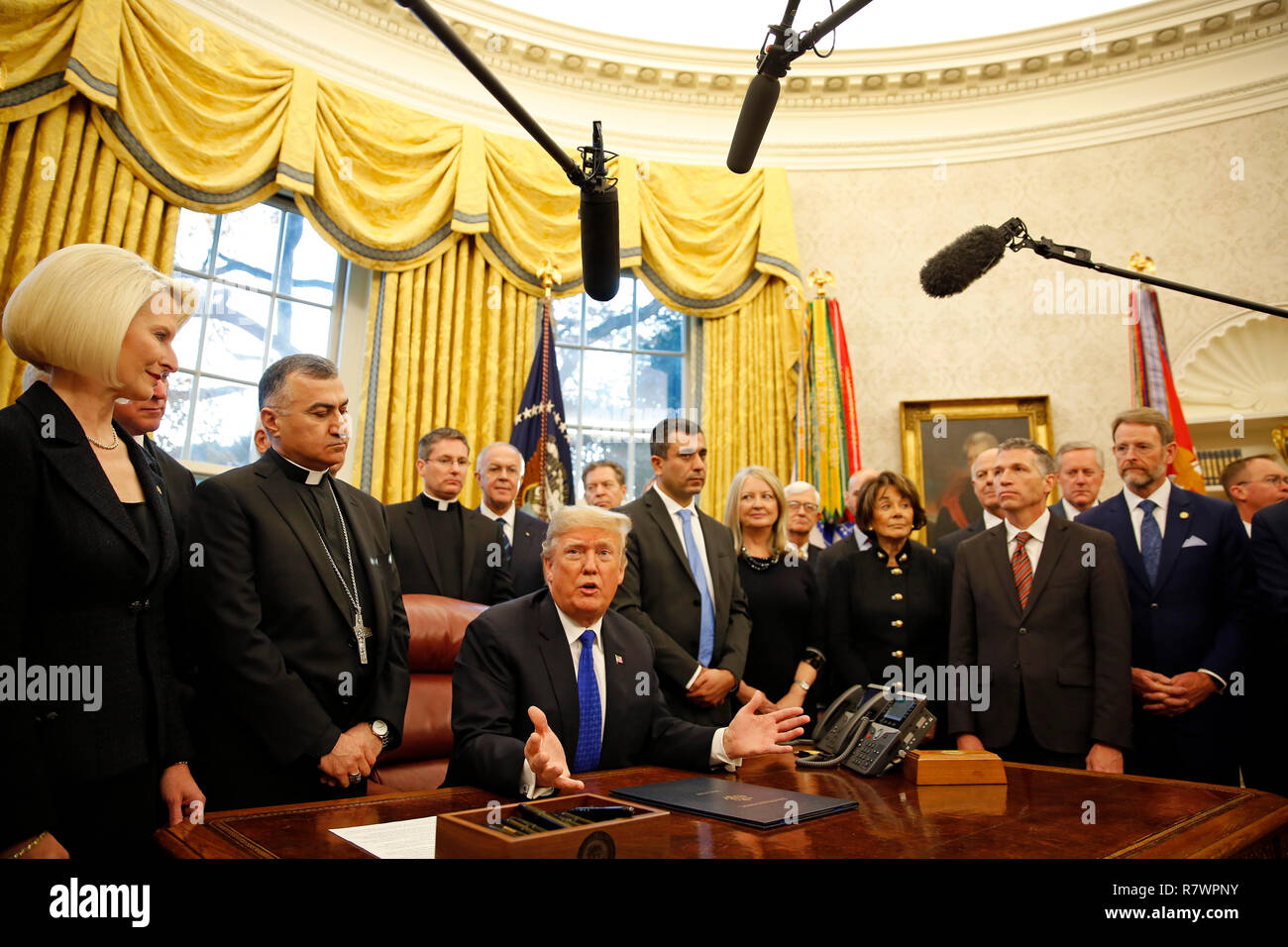 Washington, United States Of America. 11th Dec, 2018. United States President Donald J. Trump signs H.R. 390, the "Iraq and Syria Genocide Relief and Accountability Act of 2018" in the Oval Office of the White House, in Washington, DC, December 11, 2018. Credit: Martin H. Simon/CNP | usage worldwide Credit: dpa/Alamy Live News Stock Photo
