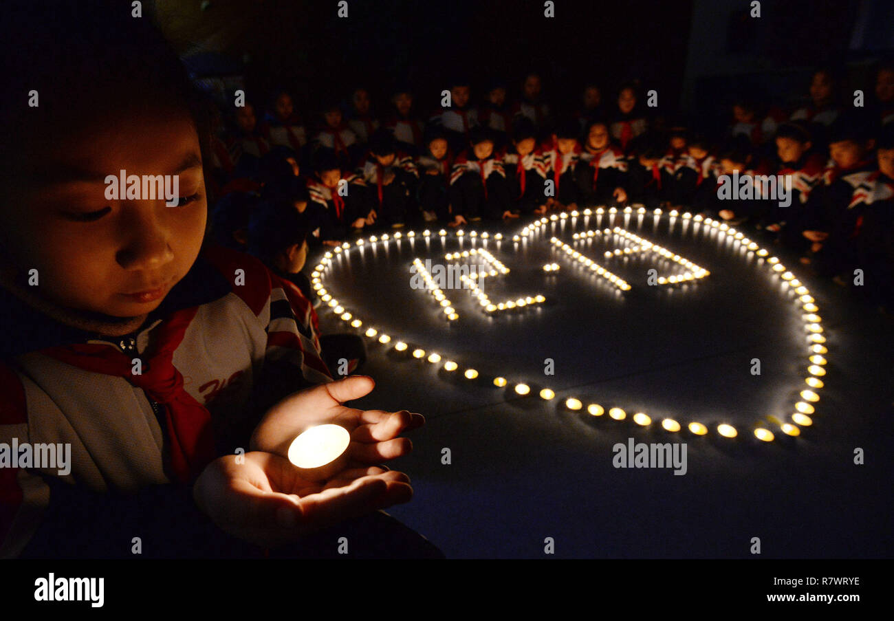 Handan, Handan, China. 12th Dec, 2018. Handan, CHINA-People light candles to mark the National Public Memorial day of Nanjing Massacre in Handan, Hebei Province. Credit: SIPA Asia/ZUMA Wire/Alamy Live News Stock Photo