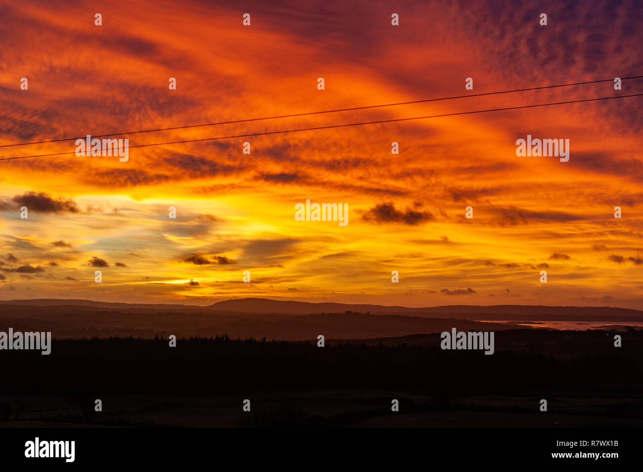 Ballydehob, West Cork, Ireland. 12th Dec, 2018. The sun rises dramatically over Ballydehob as a prelude to a day of sunshine and showers with top temperatures of 8 to 10° C. Credit: Andy Gibson/Alamy Live News. Stock Photo