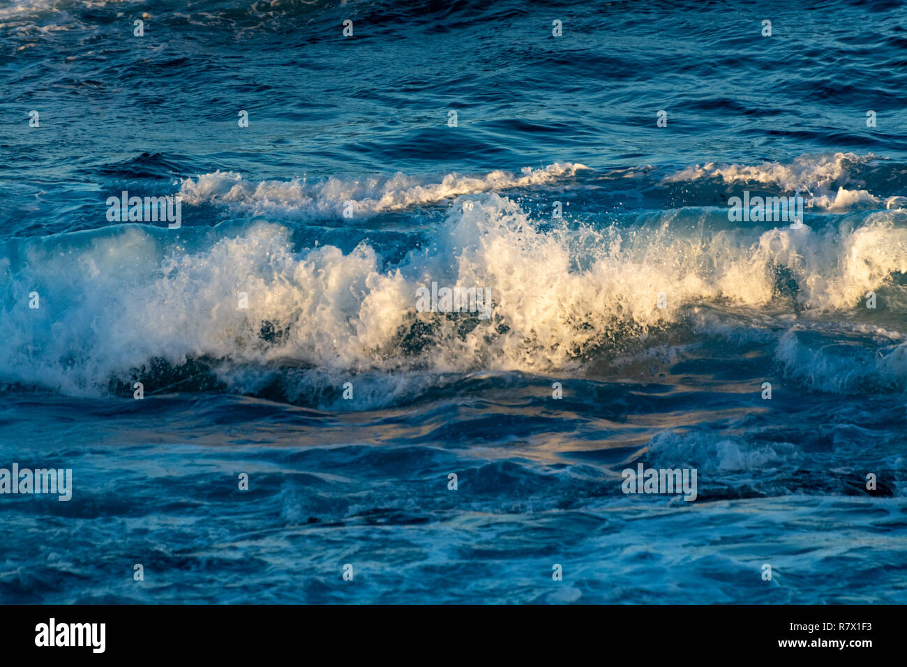 Background with dark blue ocean water waves close up on sunset Stock ...