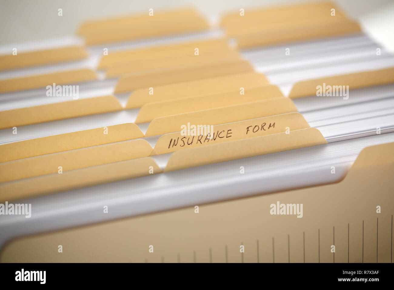 Yellow folders with labels and paper in a row Stock Photo Alamy
