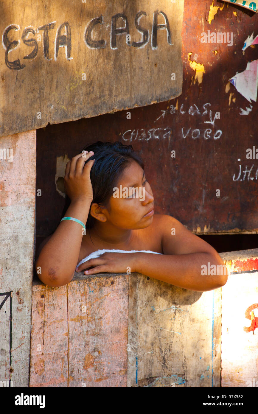 Girl daydreaming in a hut at Belen , Iquitos Stock Photo