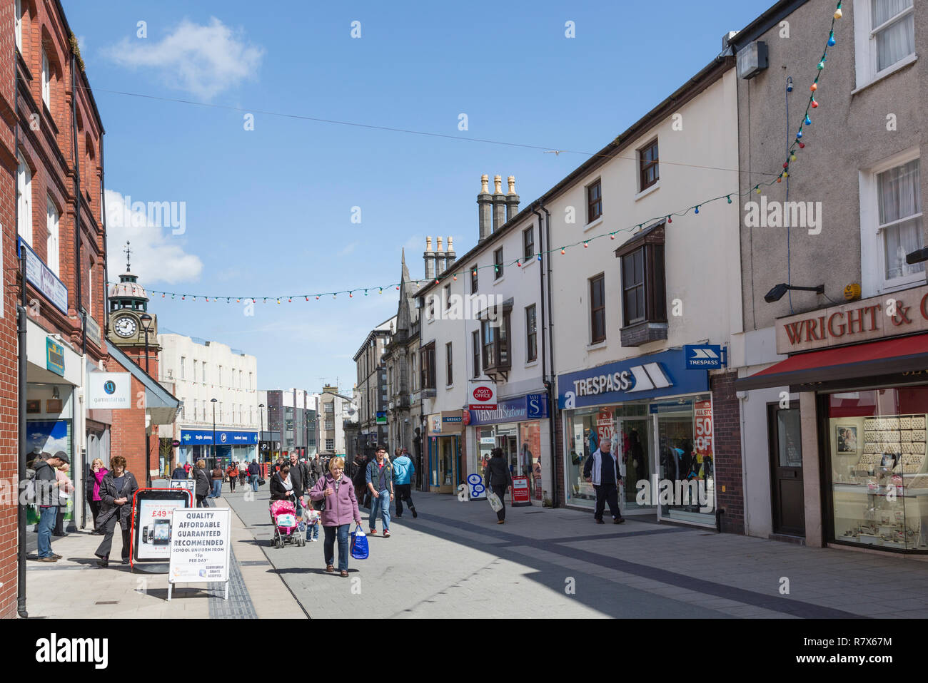 Street scene with people and shops in the city centre shopping precinct. High Street, Bangor, North Wales, UK, Great Britain Stock Photo