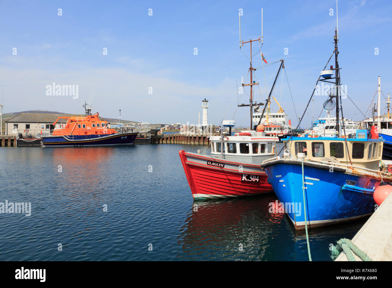 Fishing boats moored in the inner harbour with a lifeboat beyond. Kirkwall, Orkney Mainland, Scotland, UK, Great Britain Stock Photo