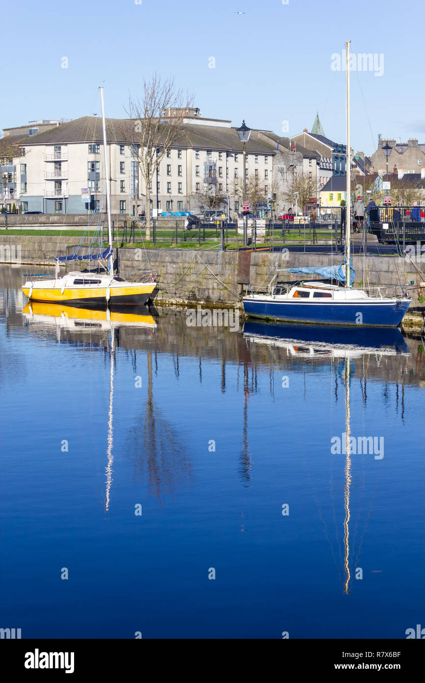 Two boats in Corrib river pier, Galway, Ireland Stock Photo - Alamy
