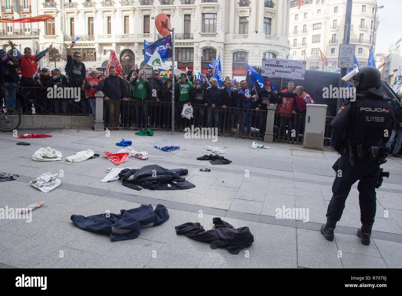 Prison workers are seen throwing their work clothes in front of the General Secretariat of Penitentiary Institutions while chanting slogans during the protest. Hundreds of striking prison workers from all parts of Spain protest on the streets of Madrid to demand a salary improvement and an increase in the workforce. Stock Photo