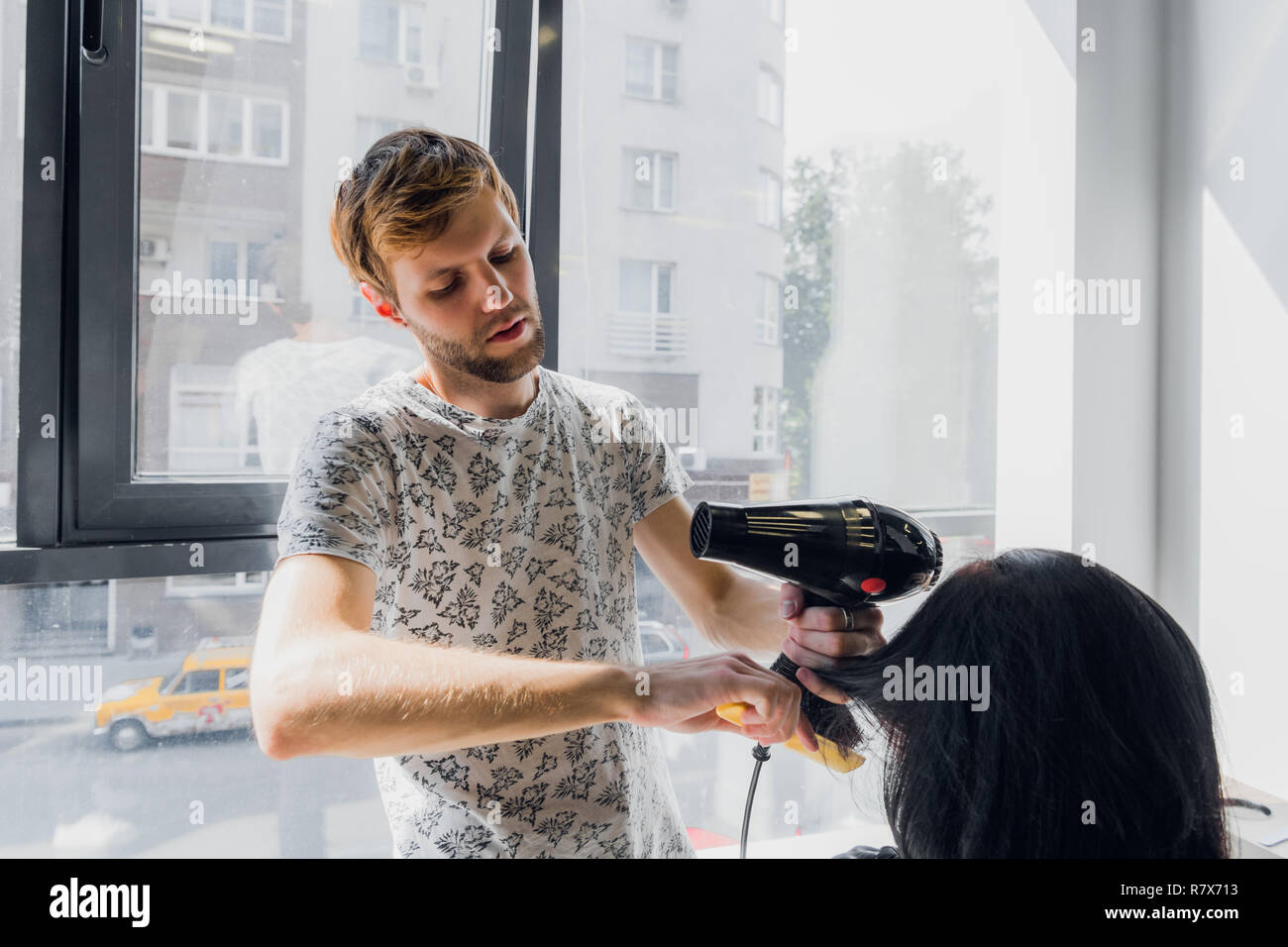 Barber drying client hair dryer hi-res stock photography and images - Alamy