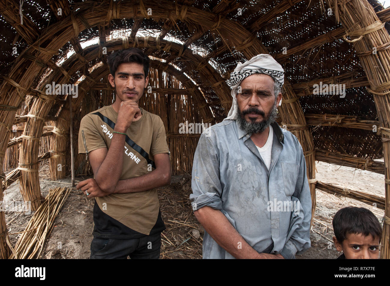 A family of buffalo herders seen in a village in the southern marshes of Iraq. Climate change, dam building in Turkey and internal water mismanagement are the main causes of a severe drought in the southern wetlands of Iraq. Stock Photo