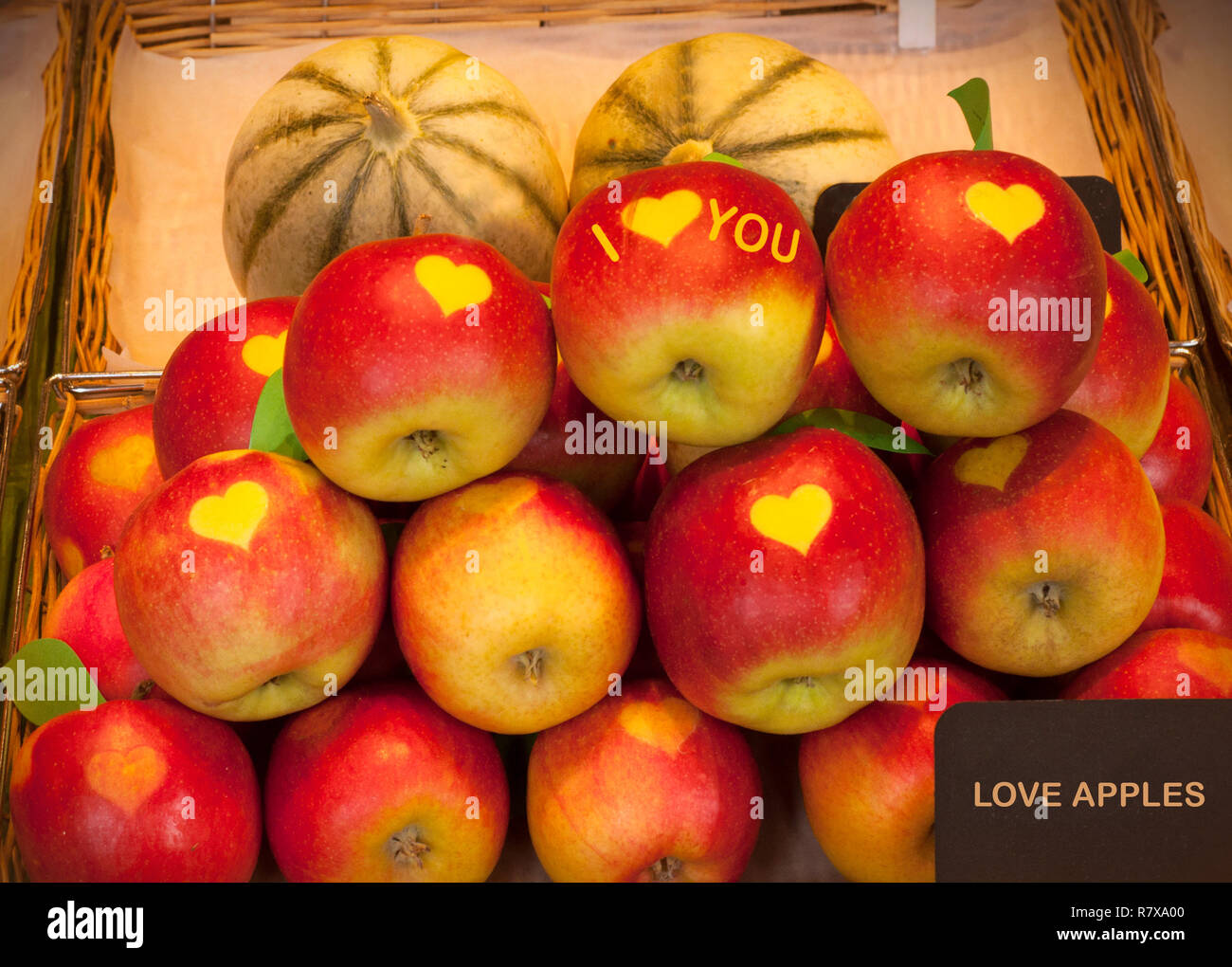 Love apples for sale in a wicker basket. Heart shape on the apples. I love you text on the apple Stock Photo