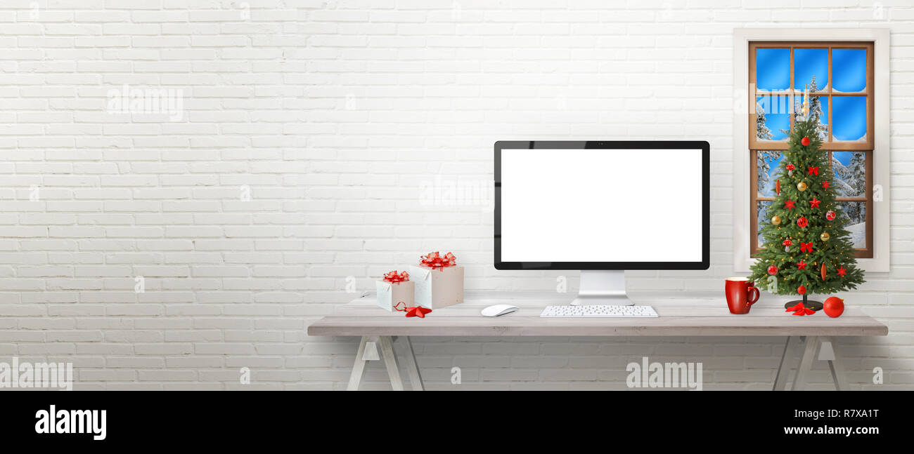 Work place with computer and Christmas decorations od desk. Copy space on left side. Isolated display for mockup. Stock Photo