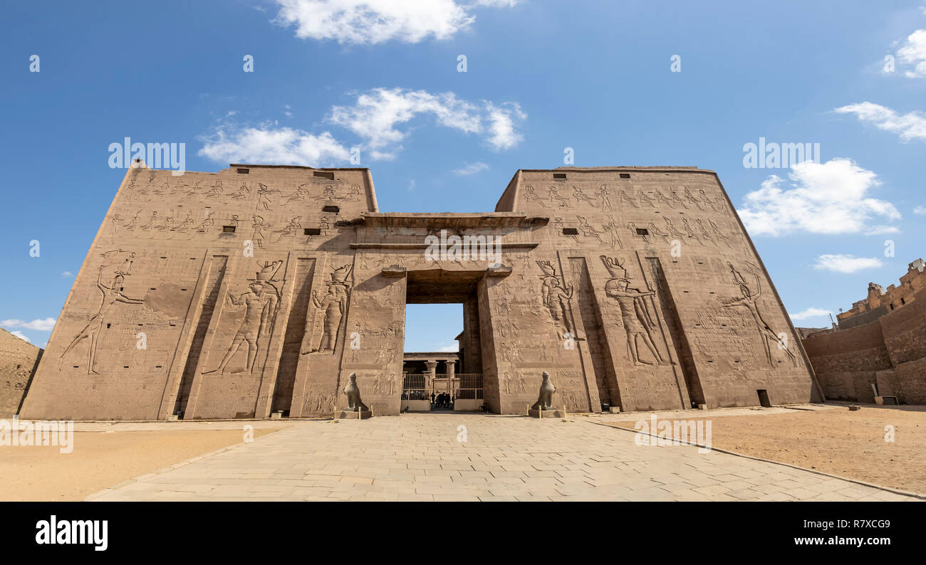 The main entrance of Edfu Temple showing the first pylon, Dedicated to the Falcon God Horus, Located on the west bank of the Nile, Edfu, Upper Egypt Stock Photo