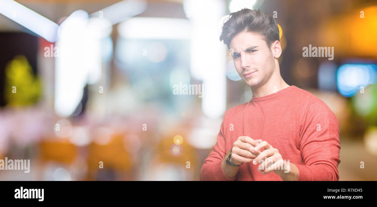 Young handsome man over isolated background disgusted expression ...
