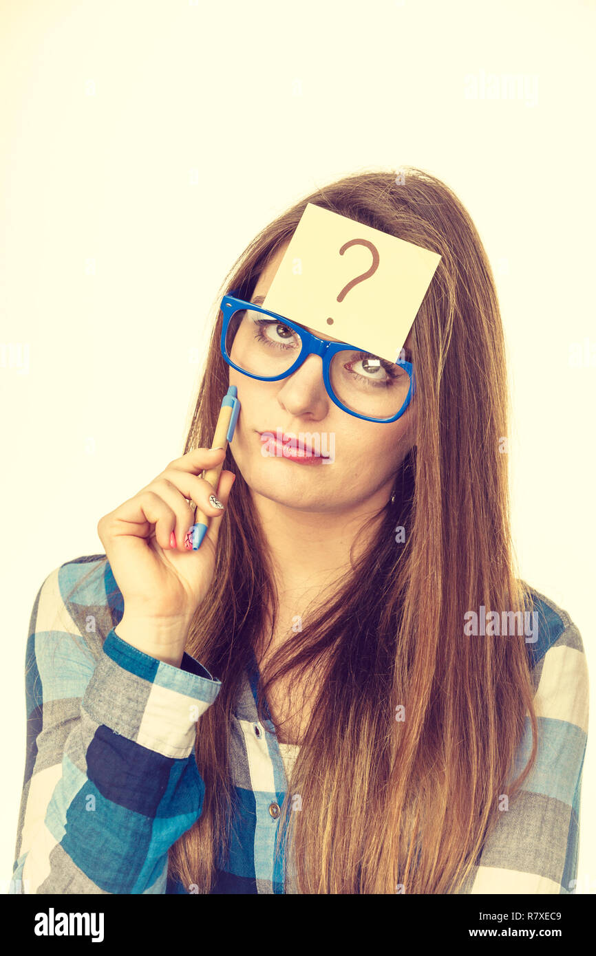 Thinking woman with big nerdy eyeglasses and question mark on forehead ...