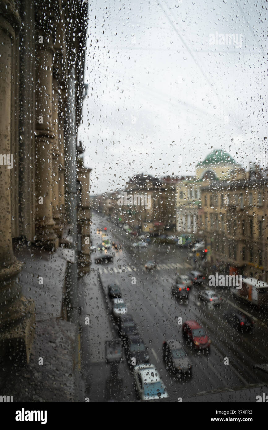 Defocussed traffic viewed through a car windscreen covered in rain Stock Photo