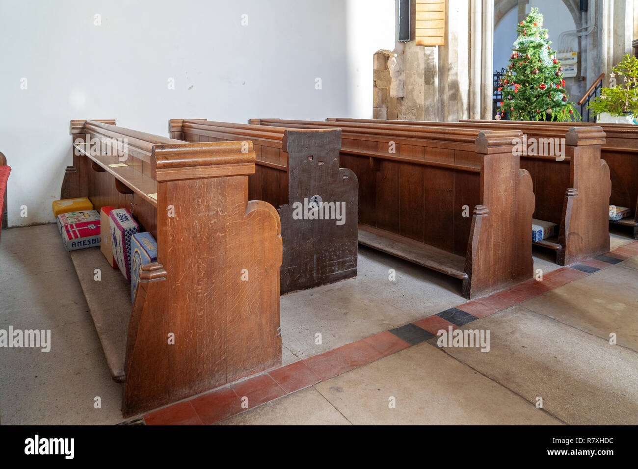 Recessed area for wheelchairs amongst church pews Stock Photo