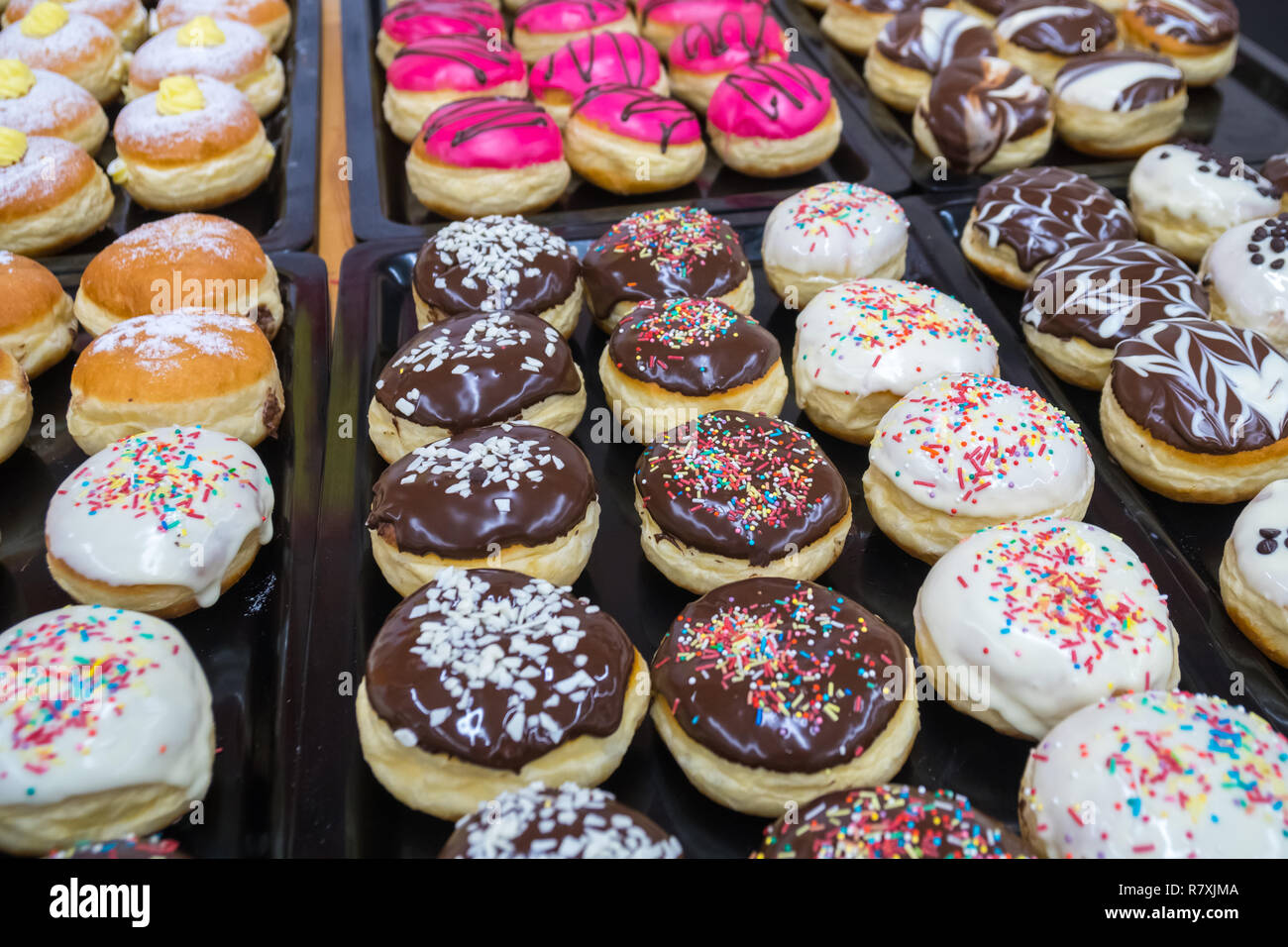 assorted donuts with chocolate frosted, pink glazed and sprinkles ...