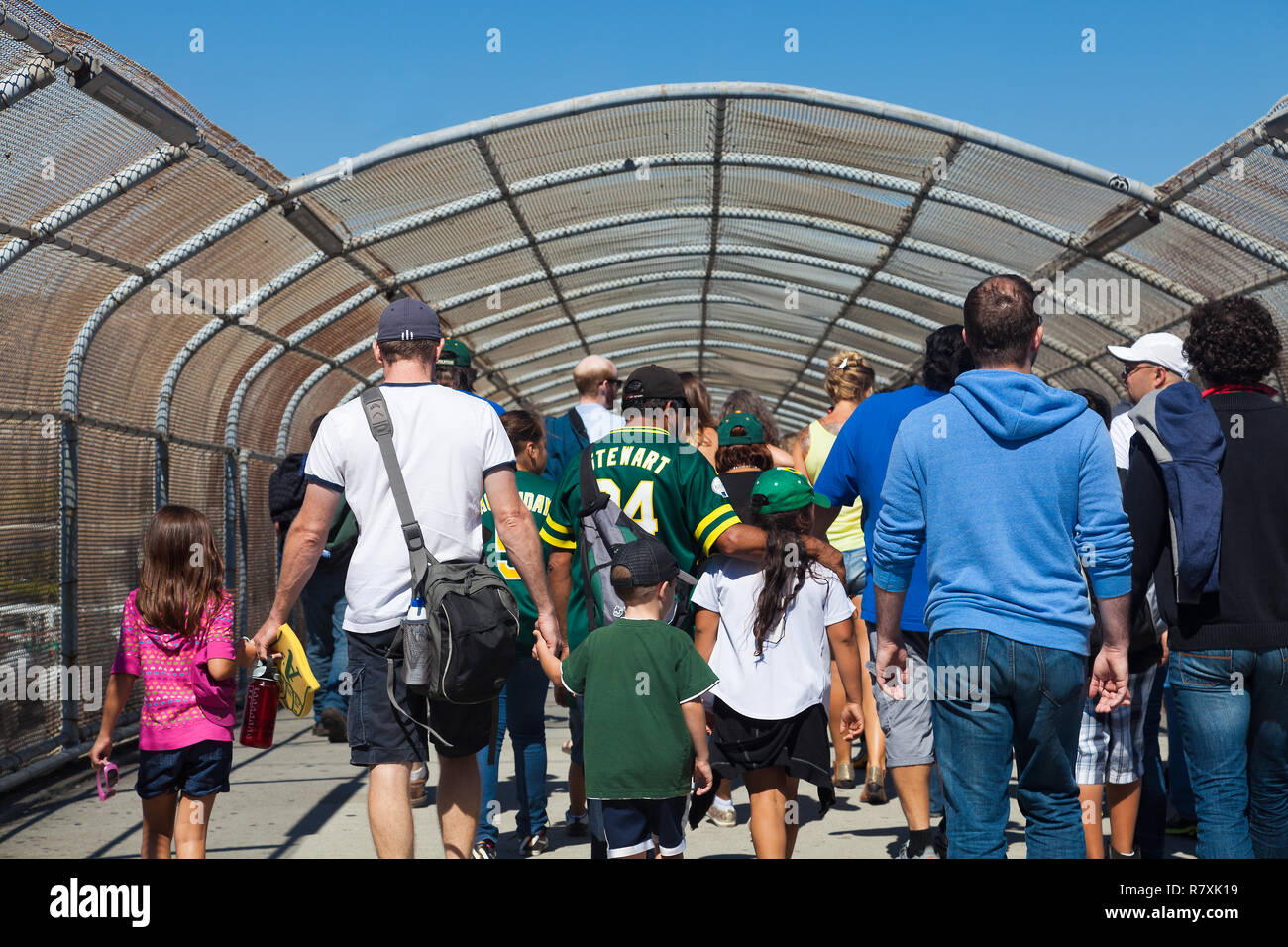 OAKLAND, CA-Aug. 22, 2012: Happy baseball fans leave the stadium after the Oakland Athletics beat the Minnesota Twins 5-1 on a sunny summer afternoon. Stock Photo