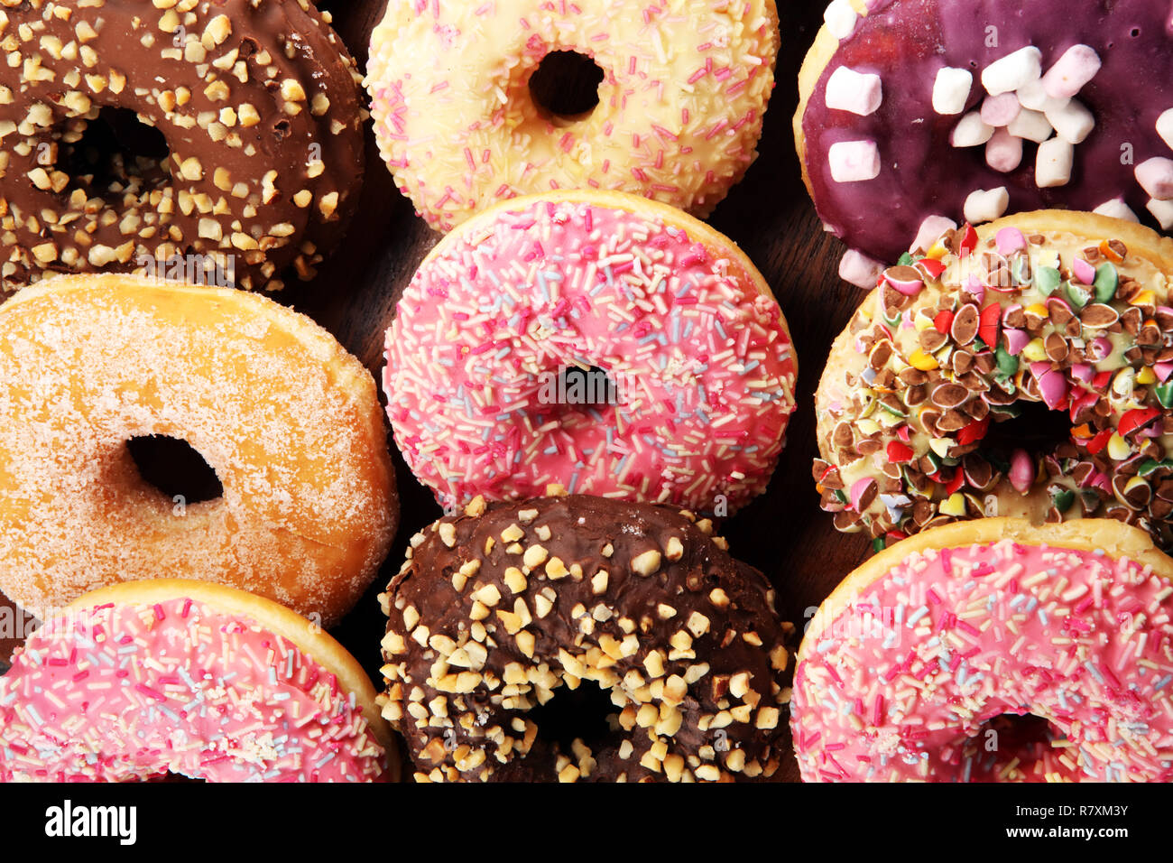 assorted donuts with chocolate frosted, pink glazed and sprinkles ...