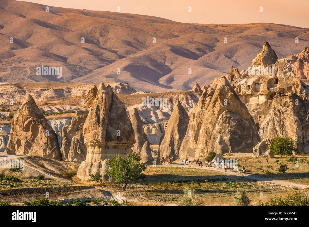 Turkey, Central Anatolia, Nev&#x15f;ehir province, Cappadocia UNESCO World Heritage Site, Kiliçlar, horse riding in the Valley of the Swords, landscape of volcanic tuff hills and vestiges of troglodyte dwellings of the Göreme National Park Stock Photo