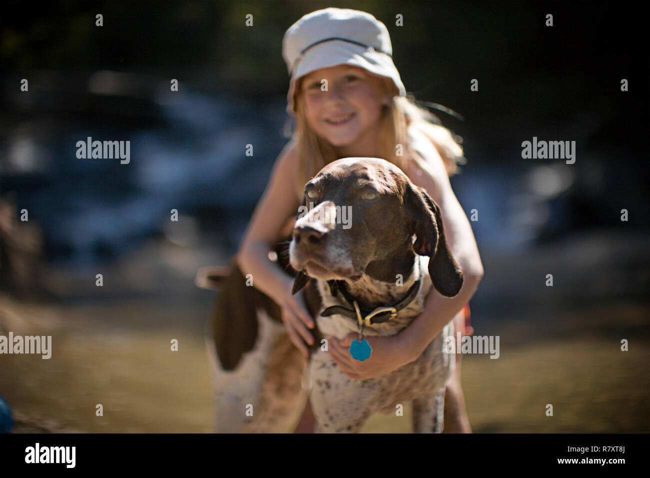 Girl hugging dog Stock Photo