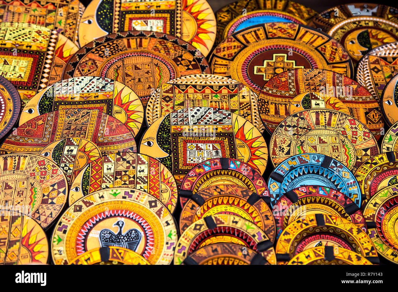 Traditional Peruvian souvenirs, oil painted wooden plates at Pisac market, Sacred Valley, Peru Stock Photo