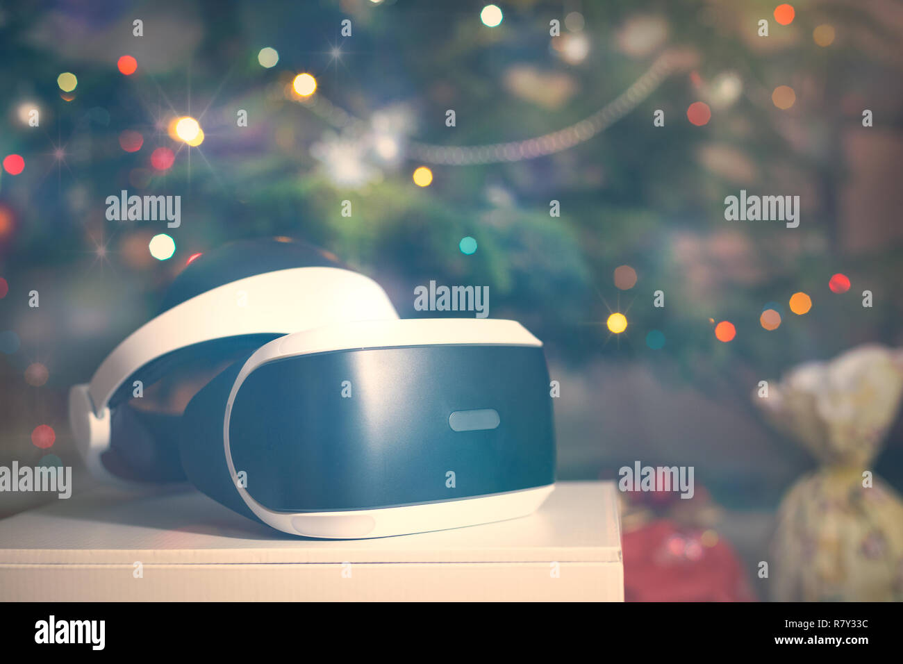 VR headset as gift under the christmas tree with defocused lights Stock Photo