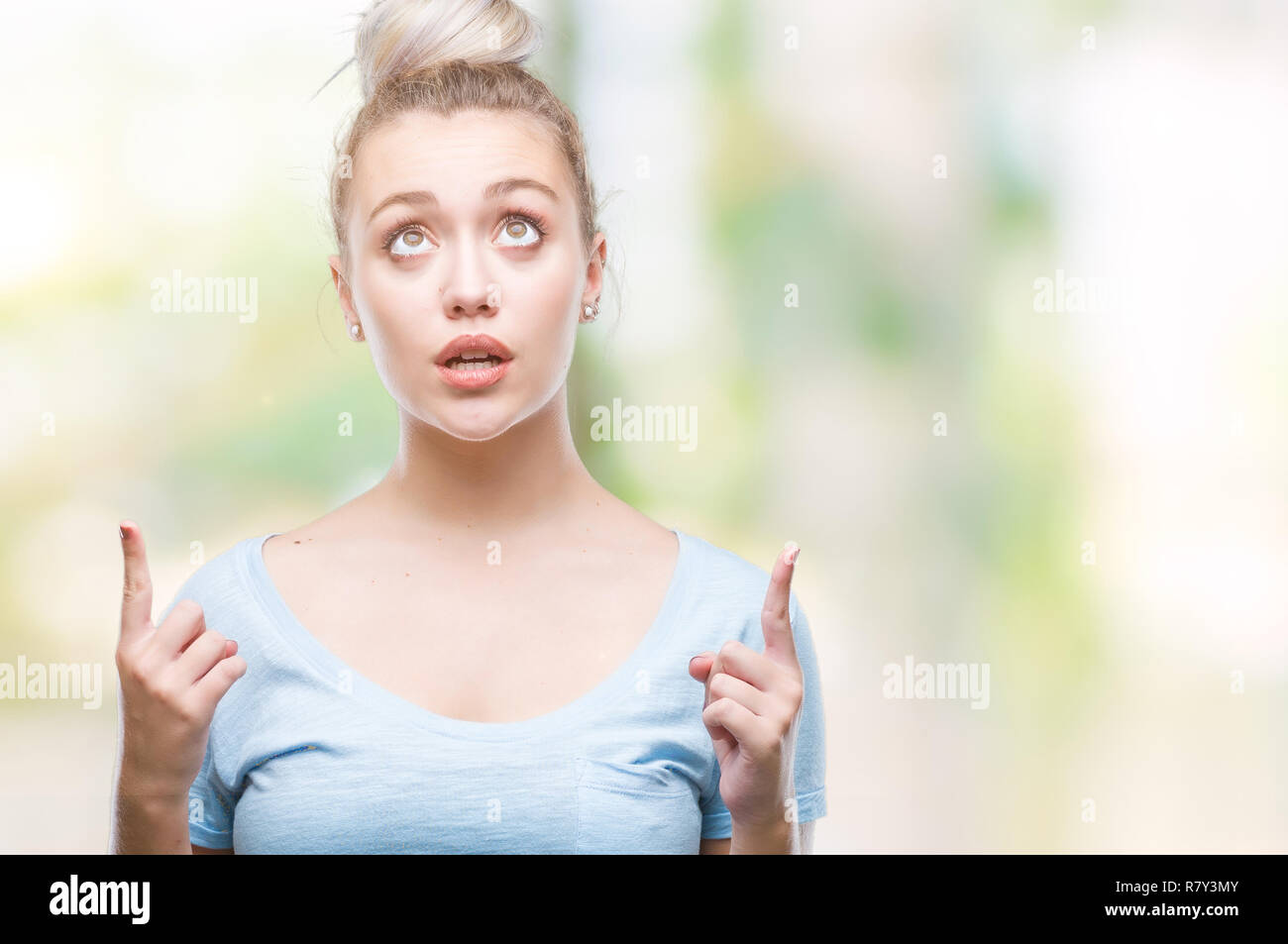 Young blonde woman over isolated background amazed and surprised ...