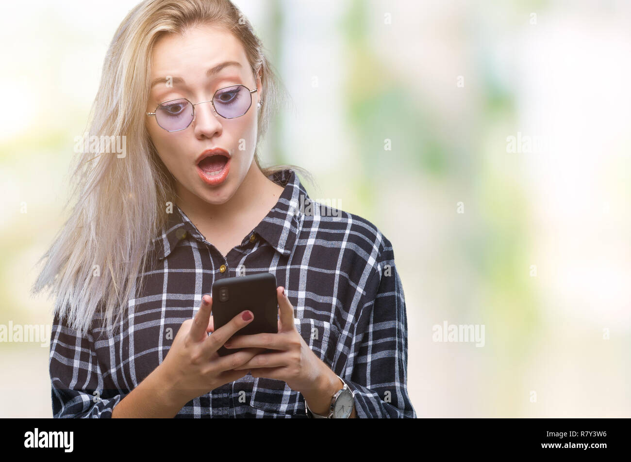 Young blonde woman texting sending message using smartphone over ...