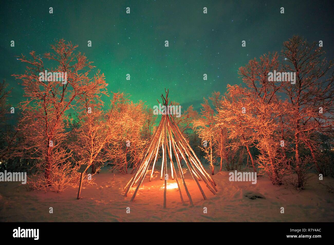 Sweden, Lapland, region listed as World Heritage by UNESCO, Norrbotten County, Aurora Borealis above a traditional Sami tent in Abisko National Park Stock Photo
