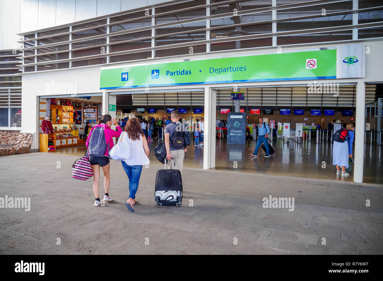 BALTRA, ECUADOR - NOVEMBER 11, 2018: Outdoor view of turists arriving with their luggages to the Baltra airport, the main one of the Galapagos Stock Photo